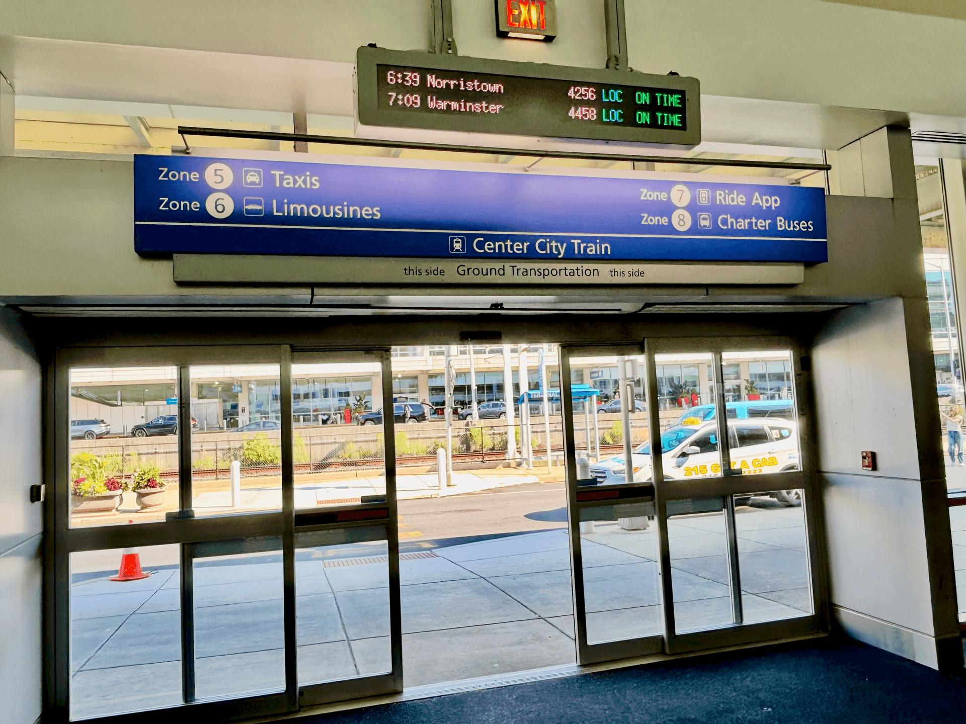 Blue sign overhead of exit doors for Ground Transportation and Zone 6
