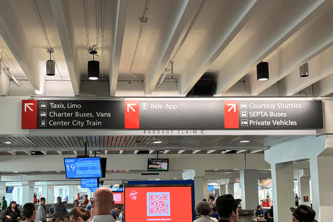 Philadelphia Airport baggage claim signs directing to taxis, limos, charter buses